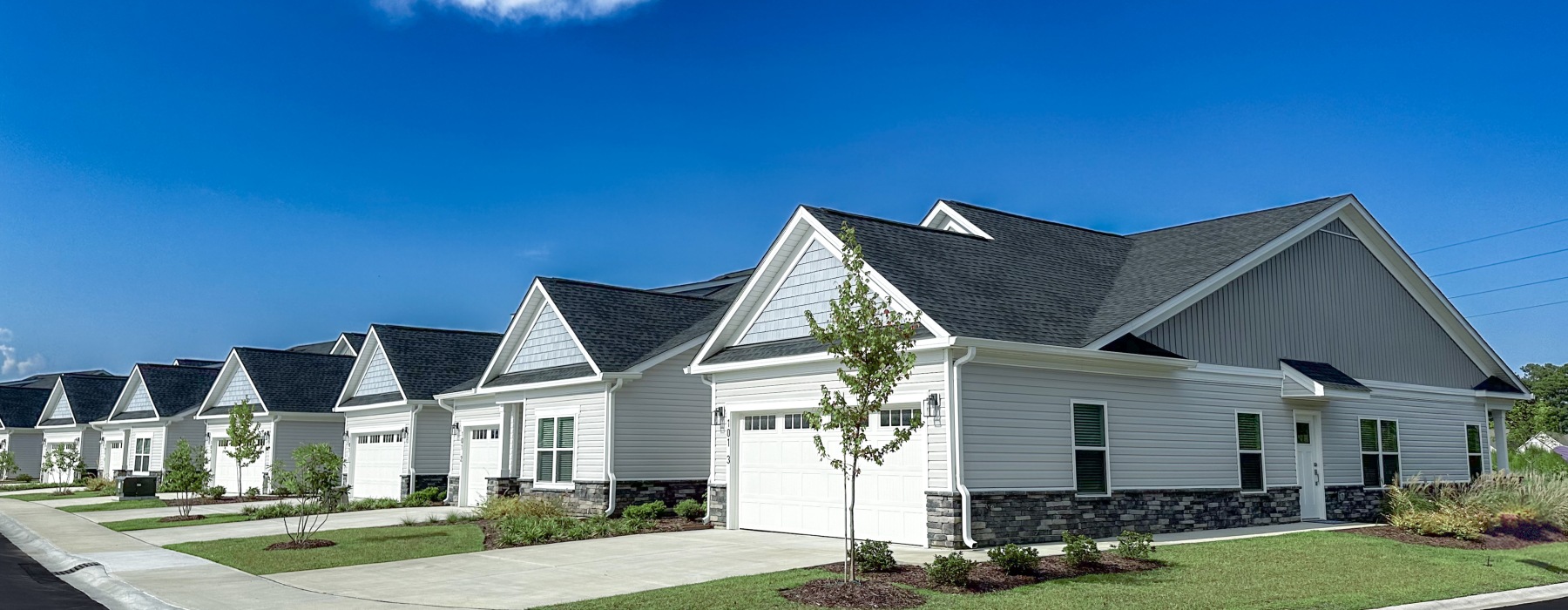 The exteriors of our 55 and older rental homes in Dallas, NC, featuring lawns, garages, and driveways.