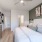 bedroom with ample space around the bed and bright lighting