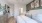bedroom with ample space around the bed and bright lighting